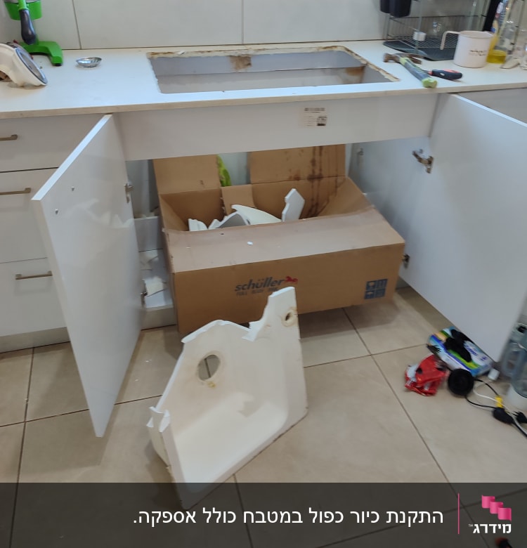 כיור מנותק על הרצפה, ארון פתוח, כלים מפוזרים